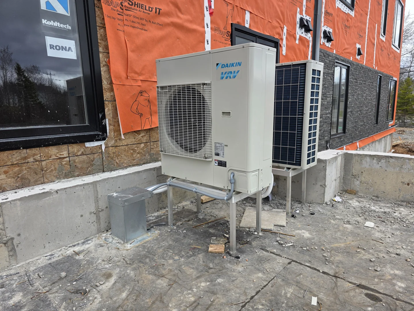 Modern cold-climate outdoor unit installed outside a newly constructed home in Nova Scotia