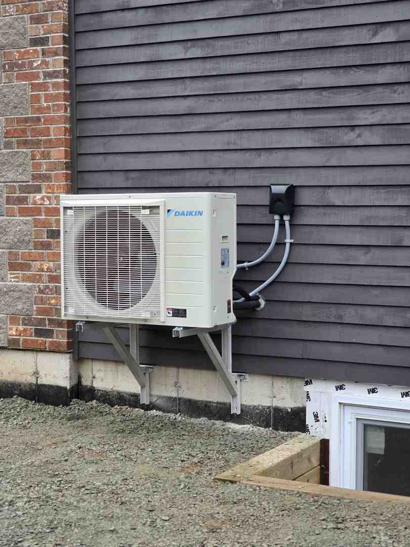 modern air source climate control system installed on the side of a newly built home modern air source climate control system installed on the side of a newly built home