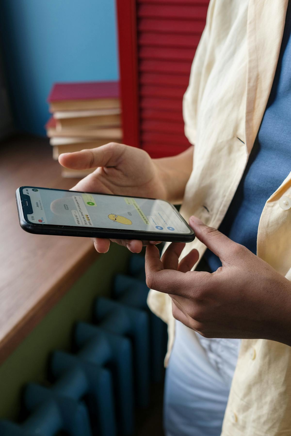 Close-up of person texting on phone at night