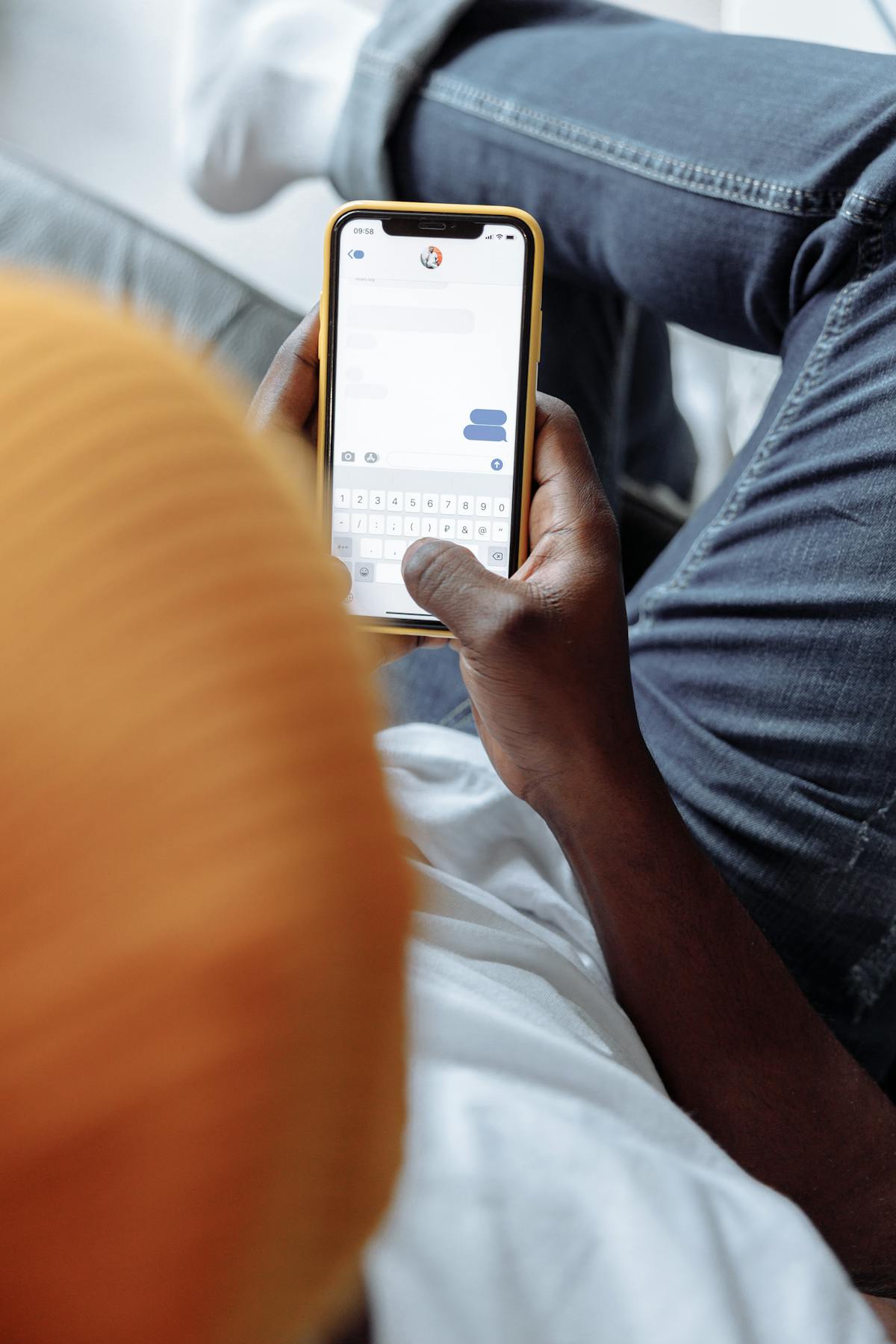 Person texting on smartphone to reply to international vacation rental guest