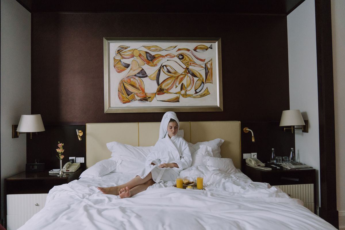 A host on a phone reviewing guest messages as a tropical storm approaches a beachfront rental