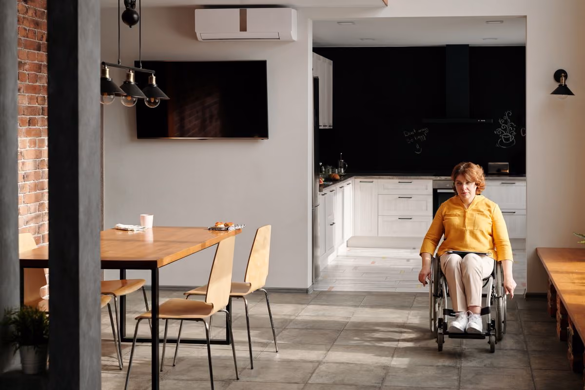Woman in a wheelchair in an accessible modern kitchen