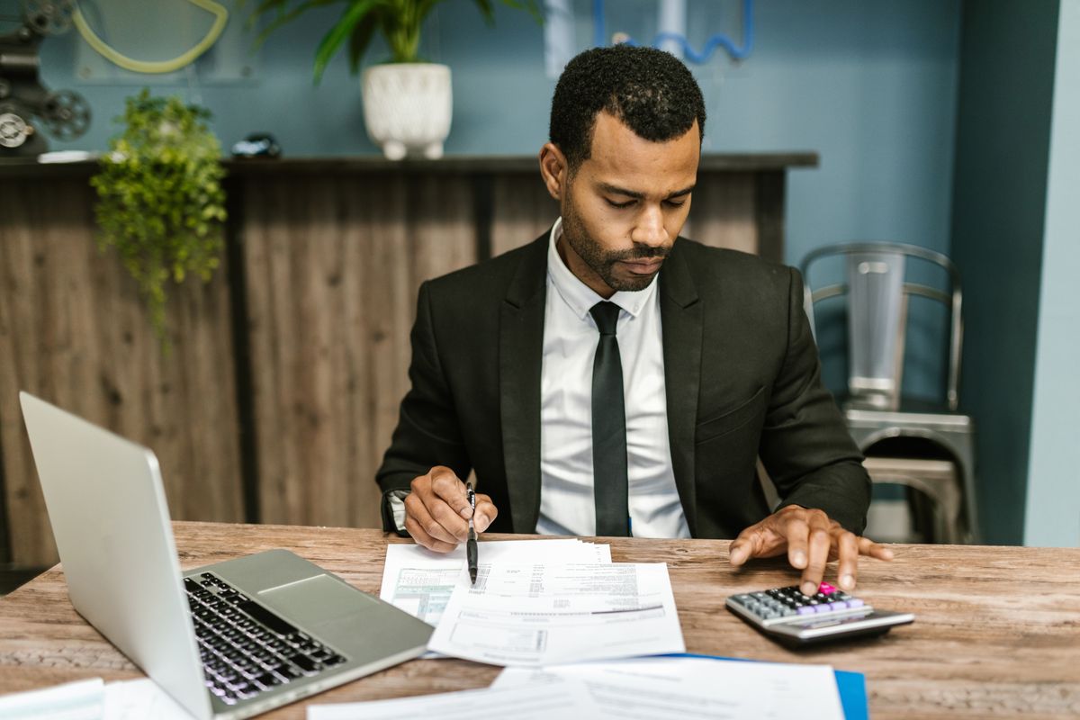 Property manager adjusting Airbnb rates for several listings from a laptop