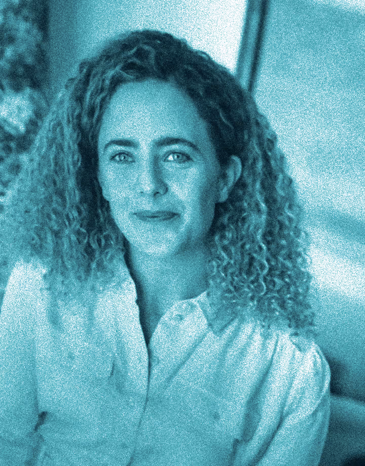 An image of a woman smiling with curly hair
