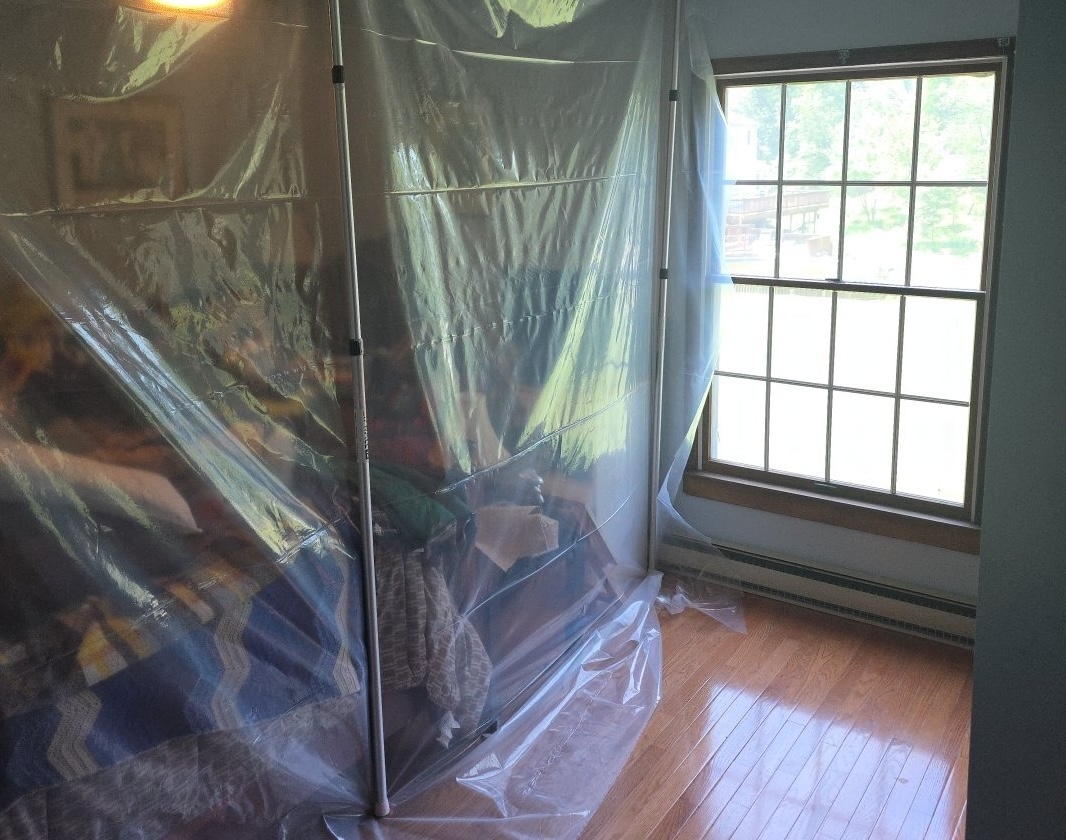 Containment: plastic used to control environment for demo and drying