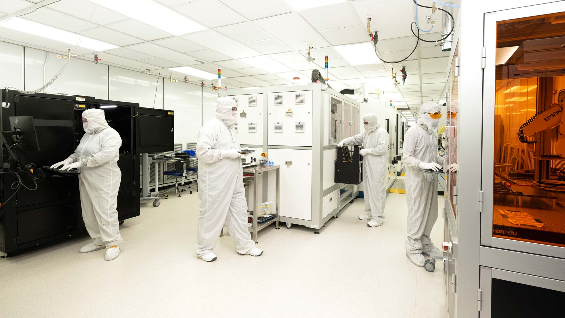 A group of Magic Leap technicians works in a clean room, preparing an iteration of a new co-optimized design.