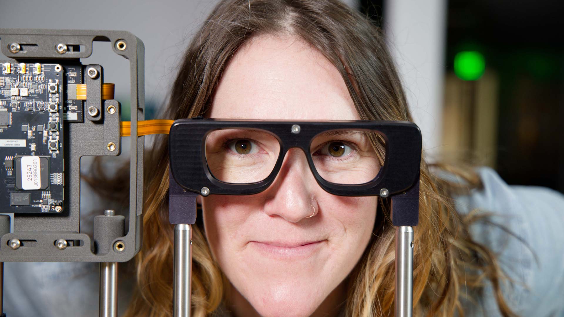 A Magic Leap employee looks through a tabletop display in the development of an AR glasses prototype.