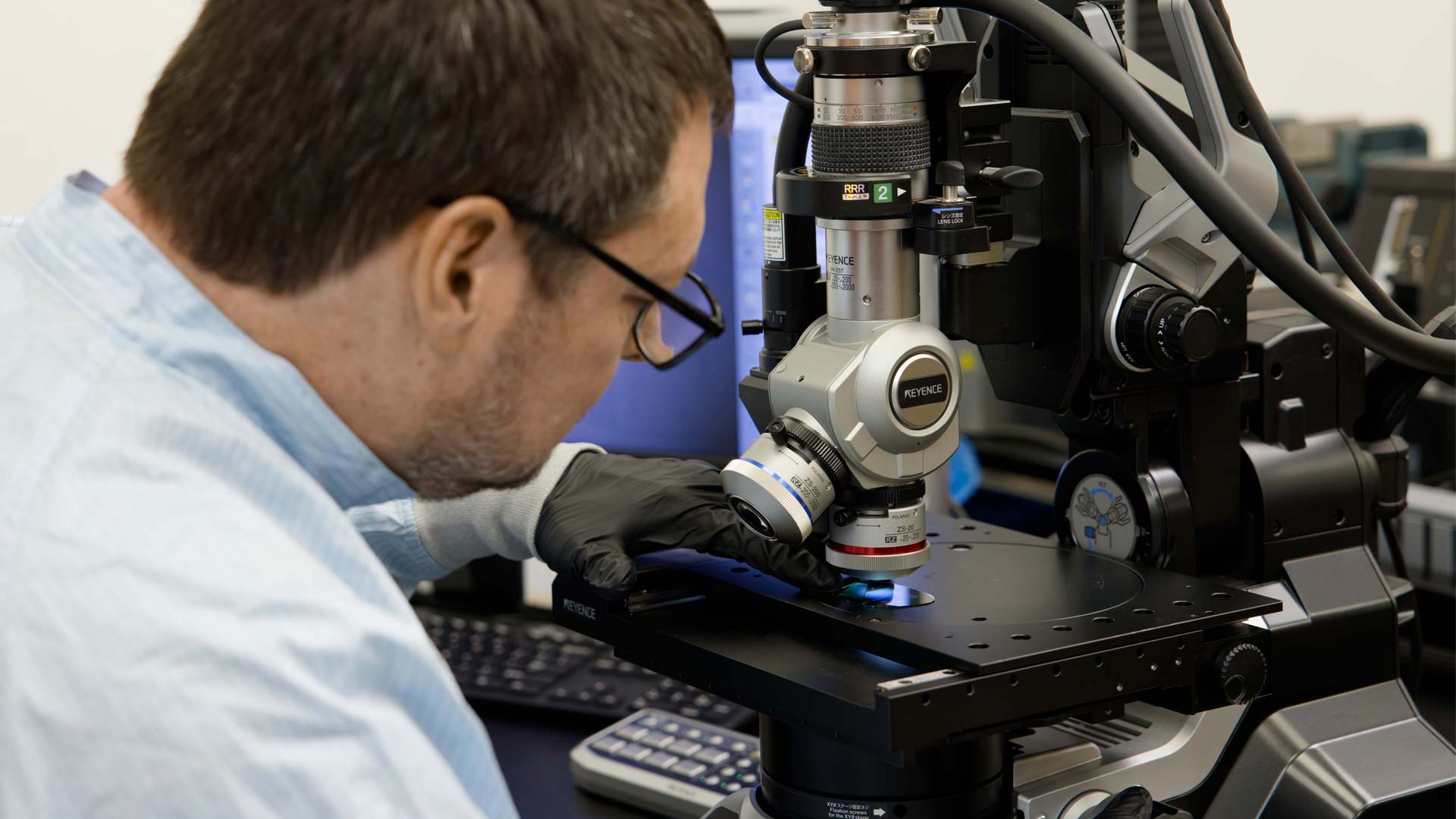 A Magic Leap engineer uses a high-power microscope to check the grating structure on a surface relief grating waveguide.