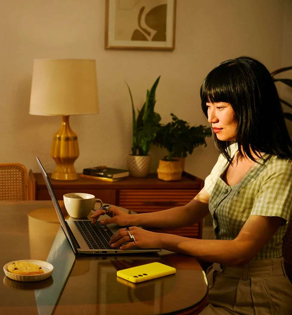 Person in their home looking at a laptop