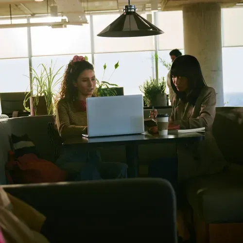 Two coworkers sitting at a table working