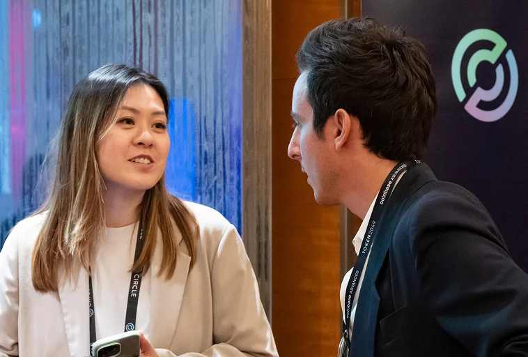 Two people talking at a Circle Appliance Program event