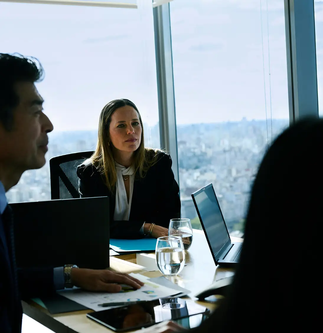 People sitting in high rise office setting.