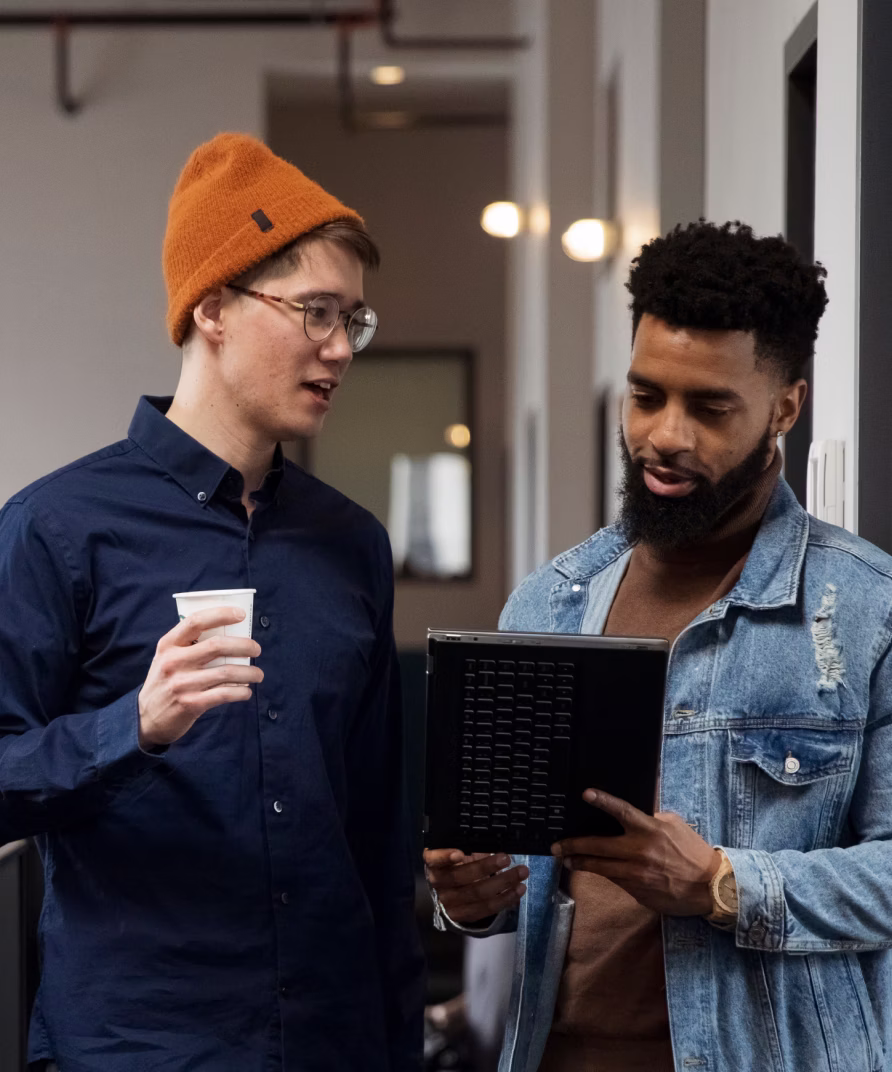Image of two people working in an office and looking at a tablet