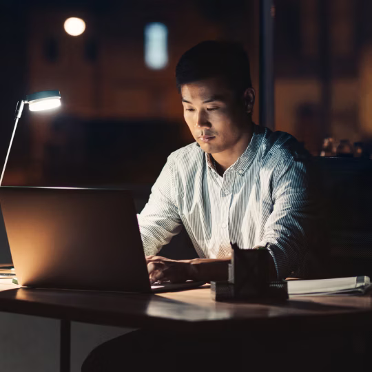 Man working on laptop at night