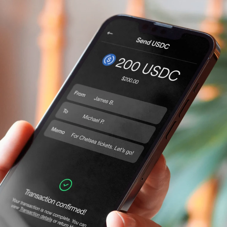 Photo of a phone showing someone sending money to a friend in an app