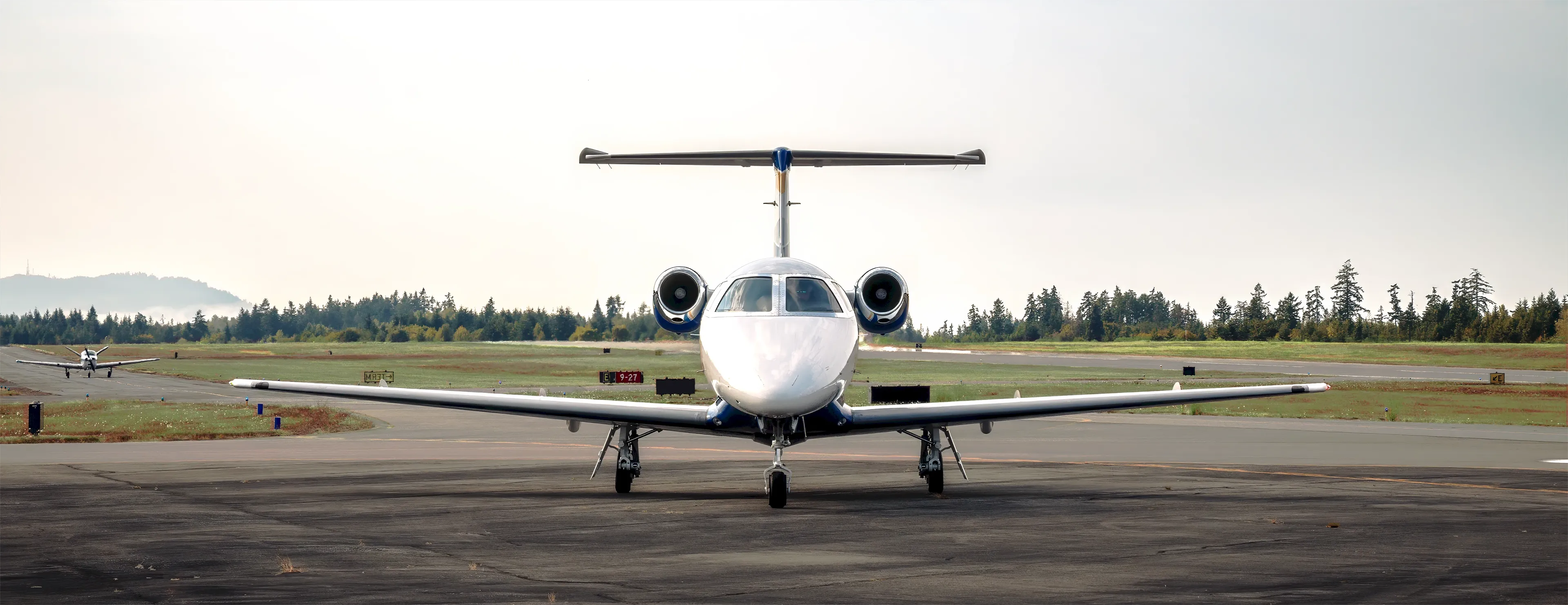 2009 Embraer Phenom 100 N983CA front view on tarmac