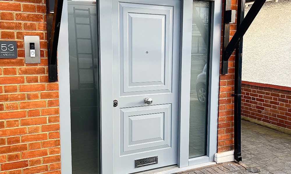 A front door painted in a muted grey colour.