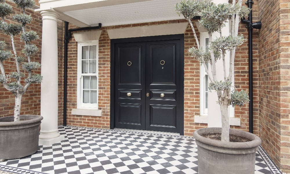 A front door with a black and white chequered floor.