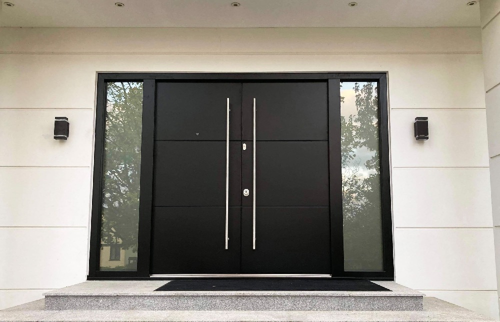 A modern minimalist porch with a black double front door.