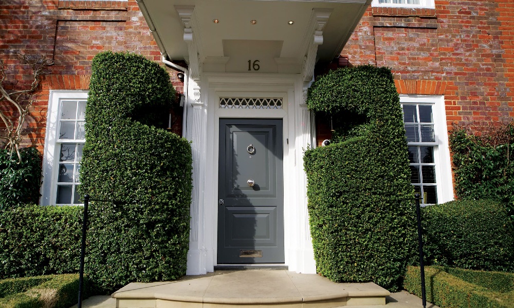 A London home with a covered porch and a security front door.