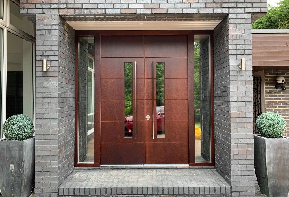 A brick porch with a modern security front door.