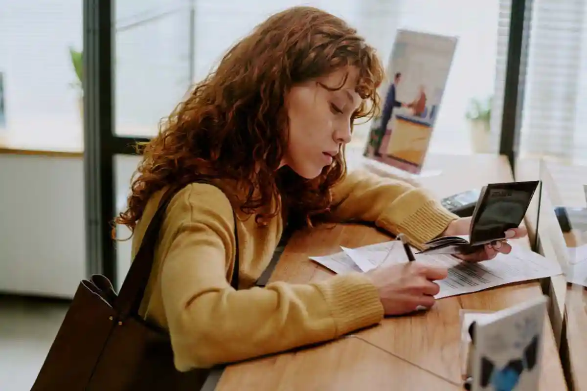 Someone fills out assistance forms at a relief desk