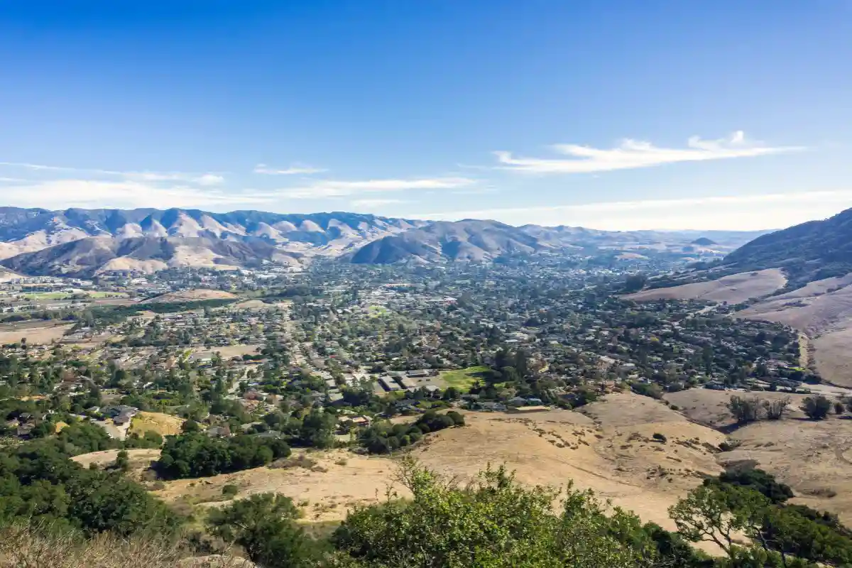 Panoramic view of the San Luis Obispo Valley from a hillside overlook with rolling hills and a clear blue sky