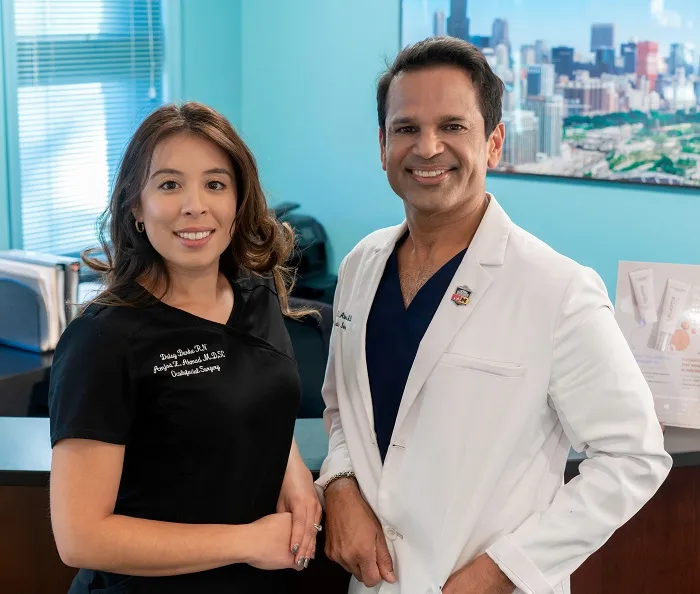 Two doctors smiling in office environment