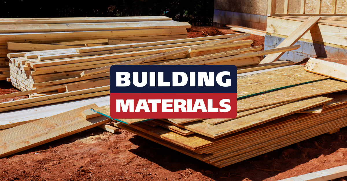 Stacks of wooden planks and plywood sheets at a construction site with the text 'BUILDING MATERIALS' overlay.