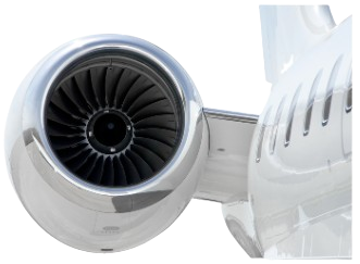 Close-up of a jet engine and the fuselage of a white private aircraft.