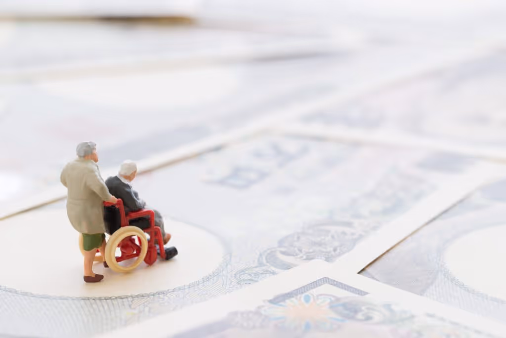 Elderly couple mini-figures placed on bank notes. Metaphor of navigating the cost of care reform.