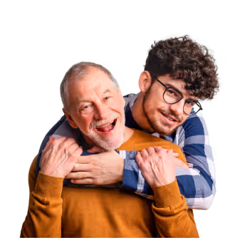 Smiling young man wearing glasses hugging his smiling grandparent 