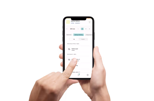 Smiling young man wearing glasses hugging his smiling grandparent 