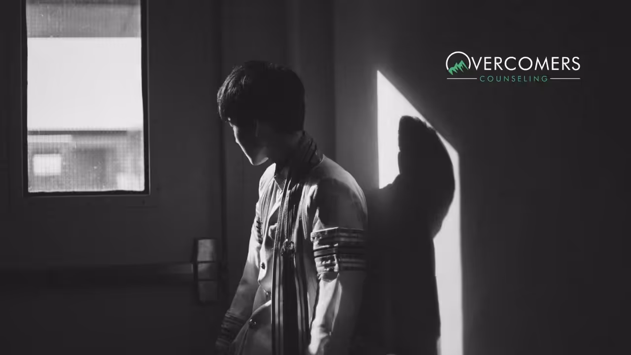 a person standing in a dark room looking out the window