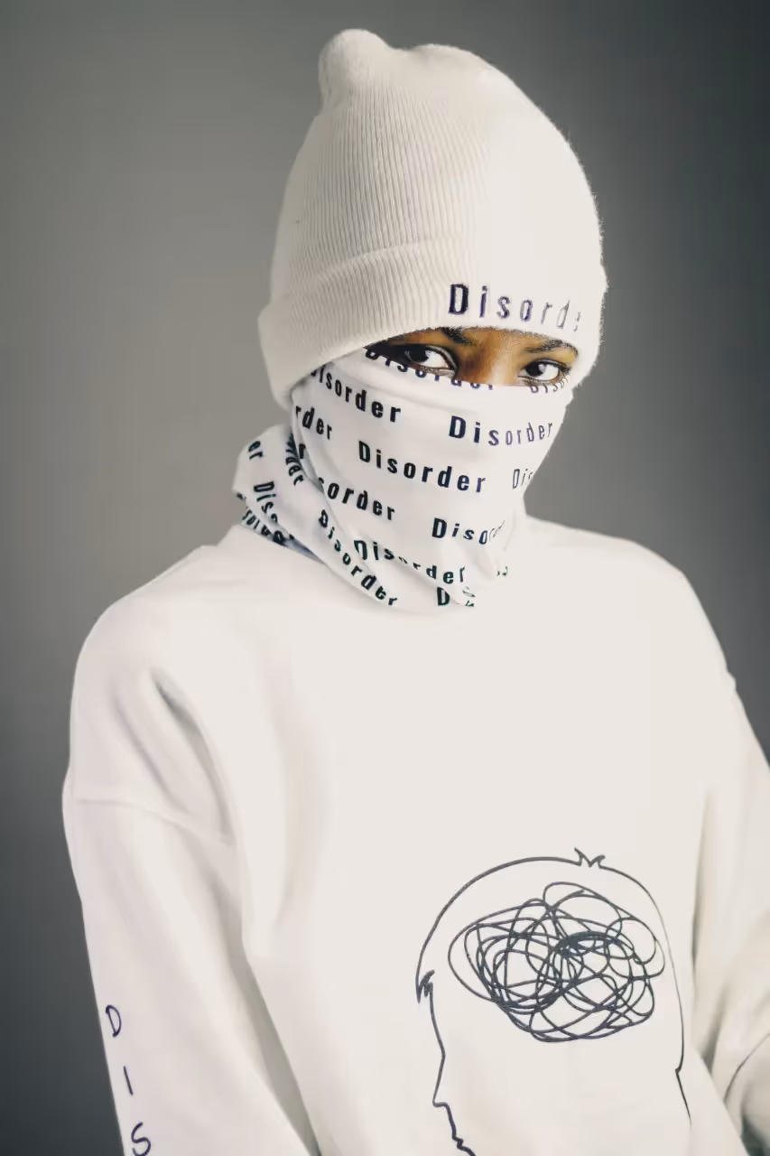 Person wearing a hat and face covering that say disorder.