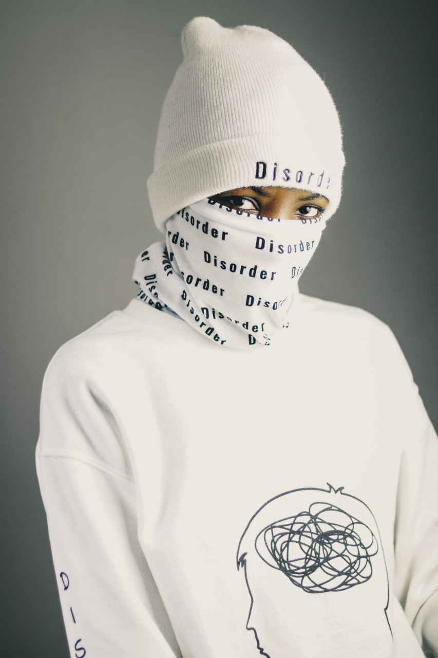 Person wearing a hat and face covering that say disorder.