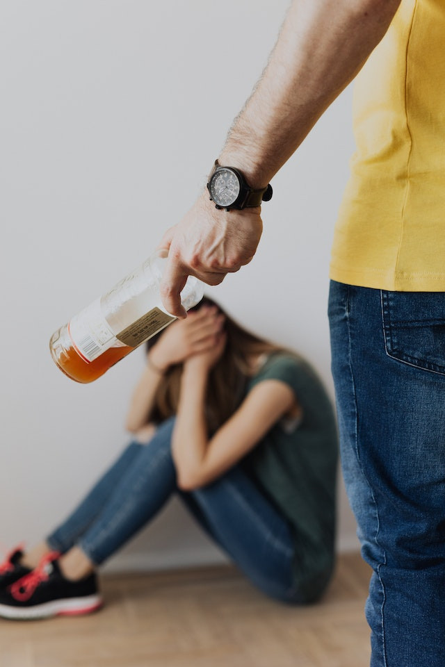 angry man with liquor bottle