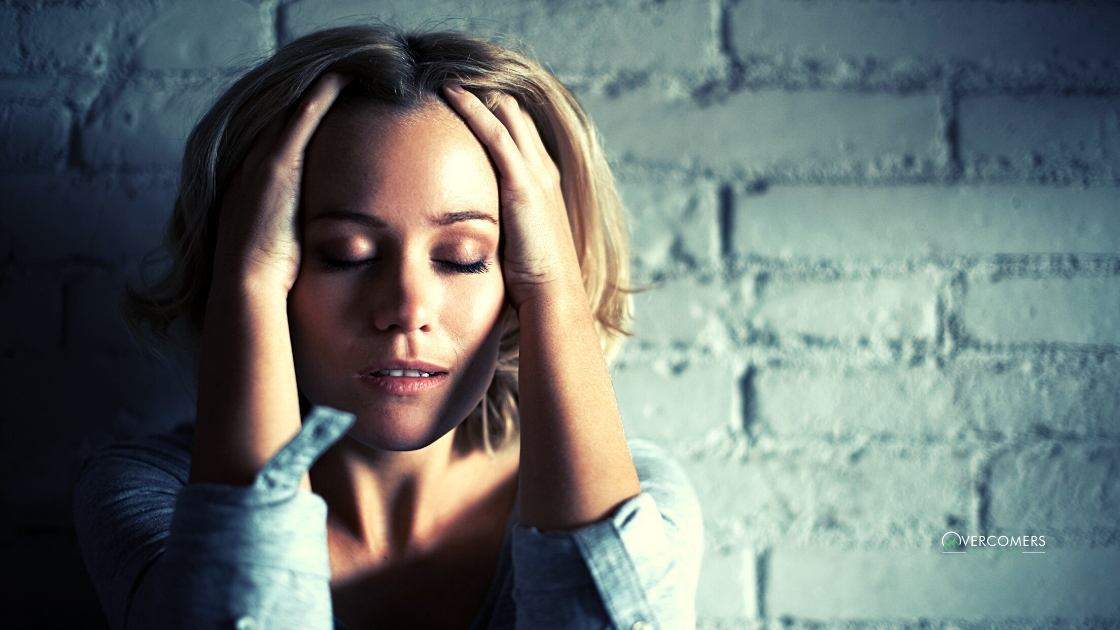 a person grabbing their head with anxiety