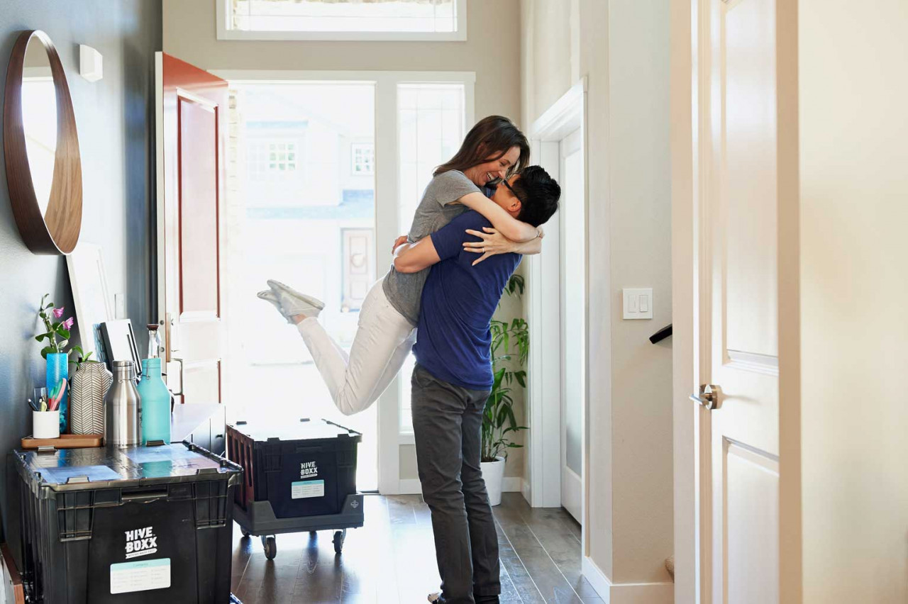 a couple embracing each other in a hallway