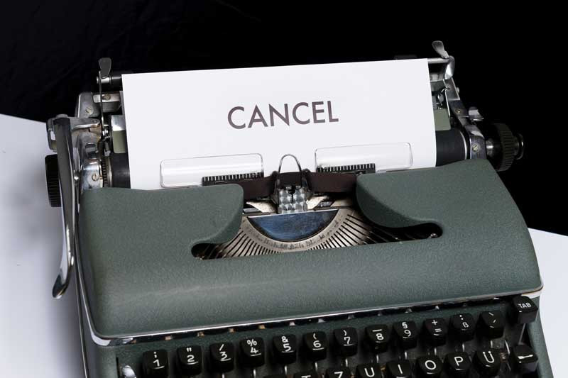 a typewriter with paper that says cancel