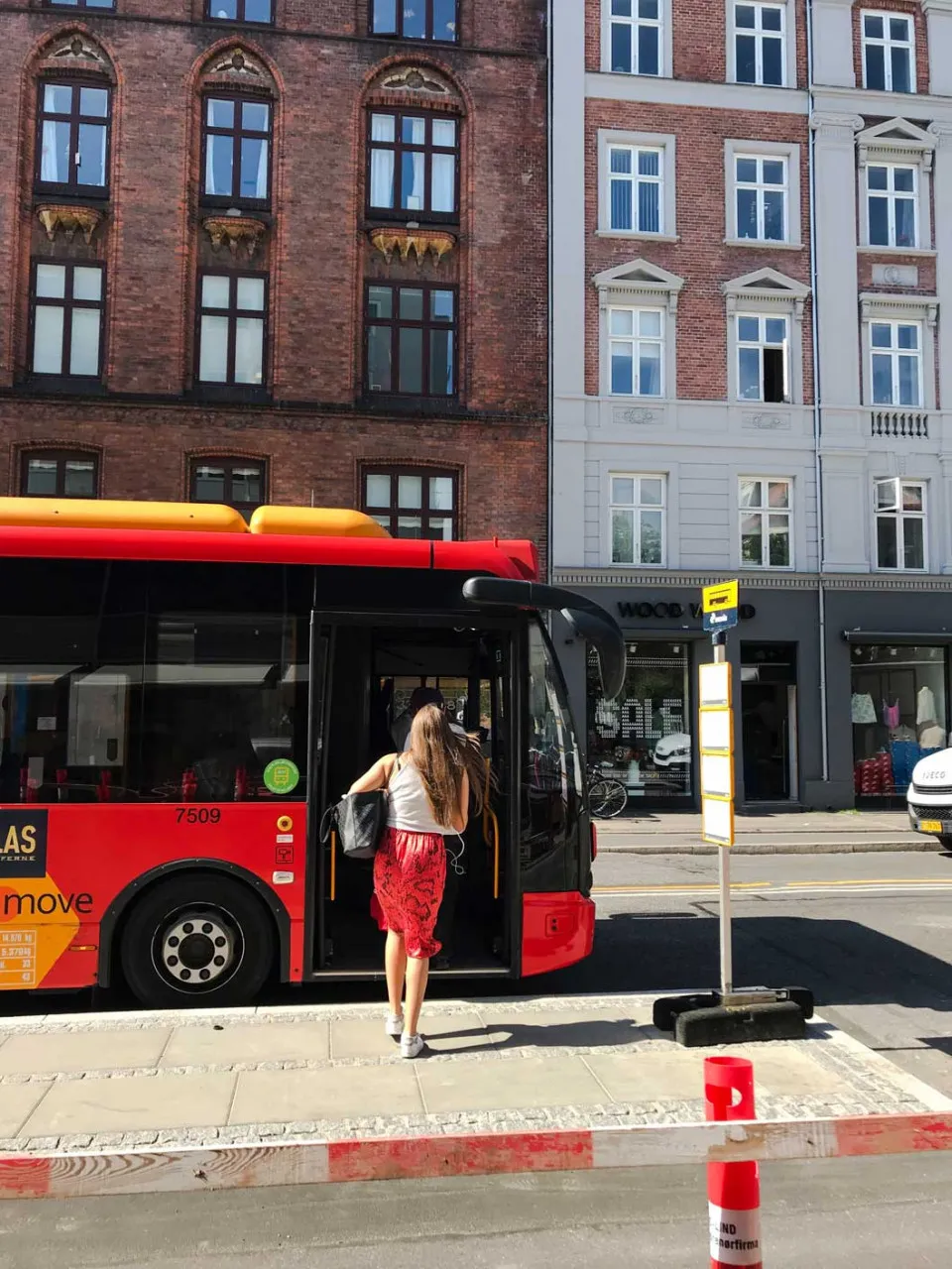 a woman walking onto a bus
