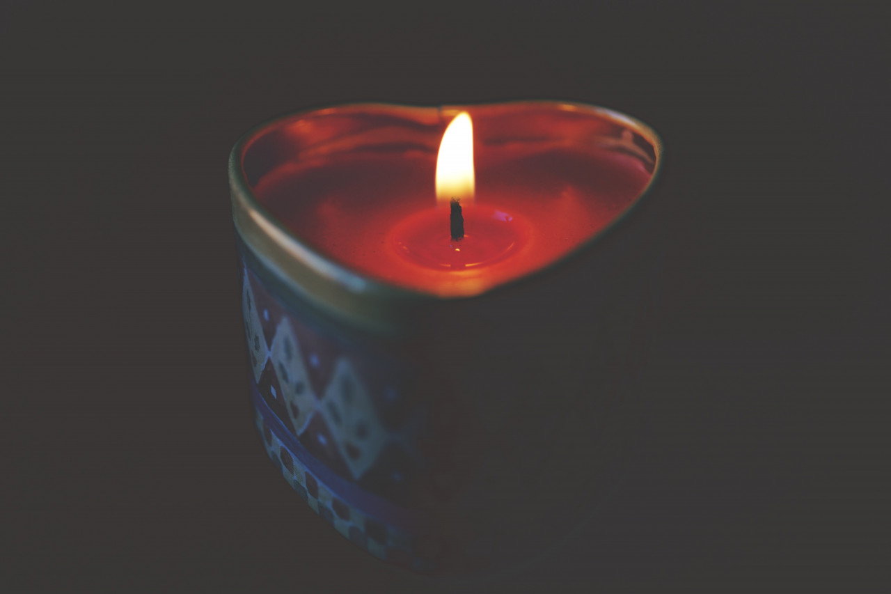 a lit heart-shaped candle