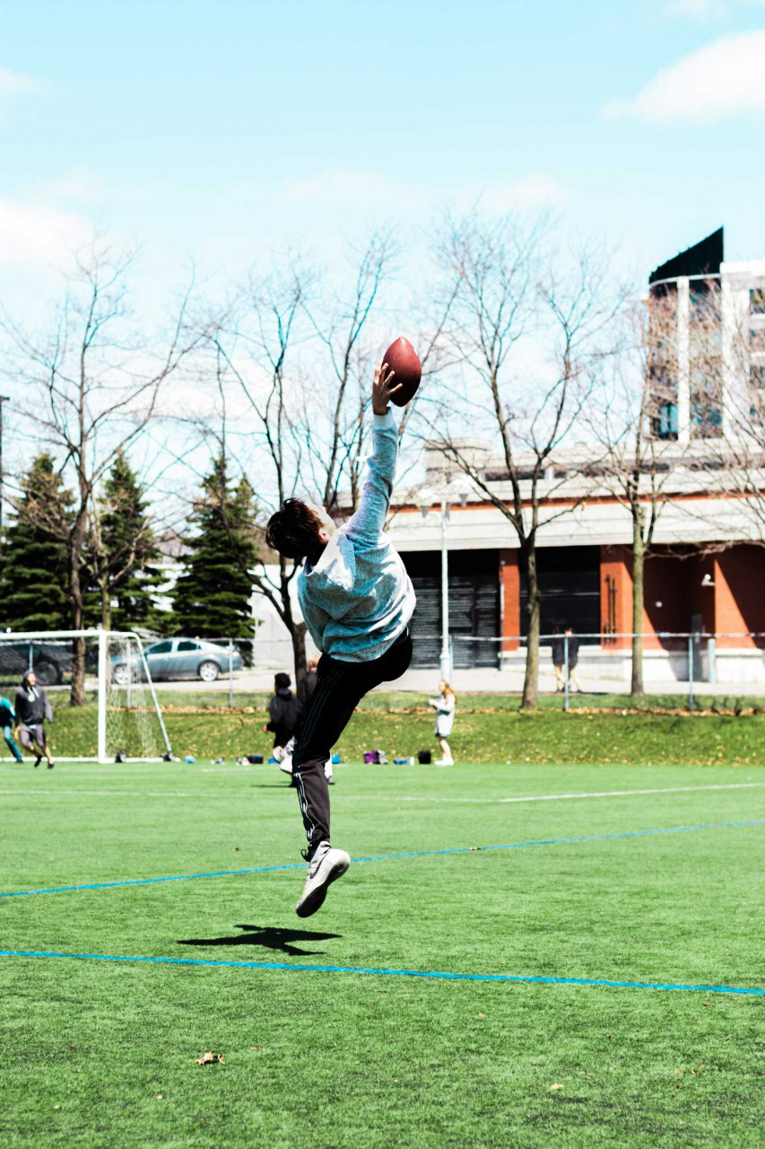 a young kid catching a football