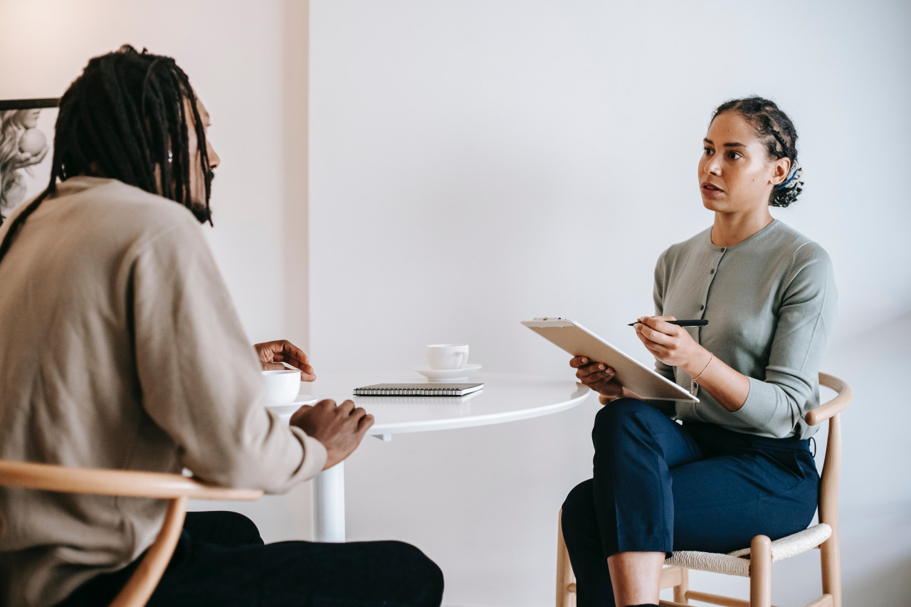Woman and a man sitting at a table talking