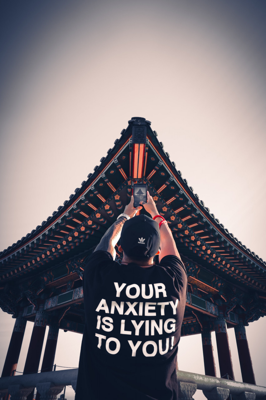 A guy wearing a shirt that says Your Anxiety is Lying to You