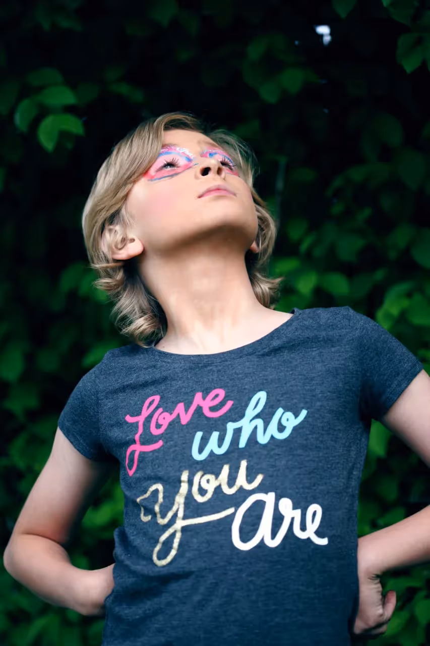 Girl looking up wearing a shirt that says Love Who You Are