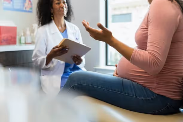 A pregnant woman visiting with her doctor