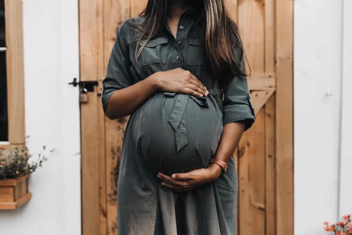 pregnant person holding belly