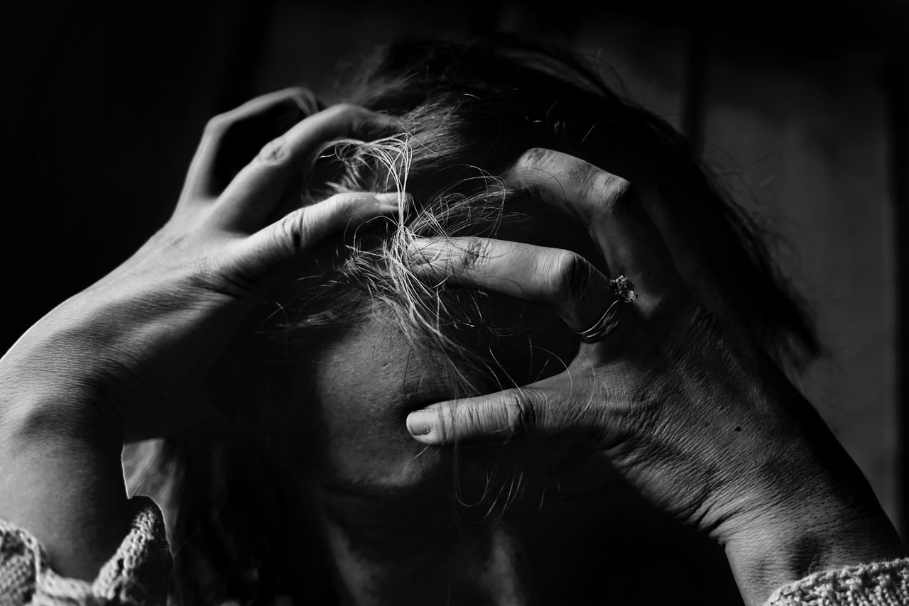 Person digging their fingers into their head