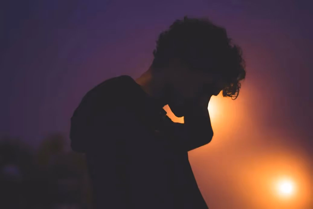 a person rubbing the back of their neck